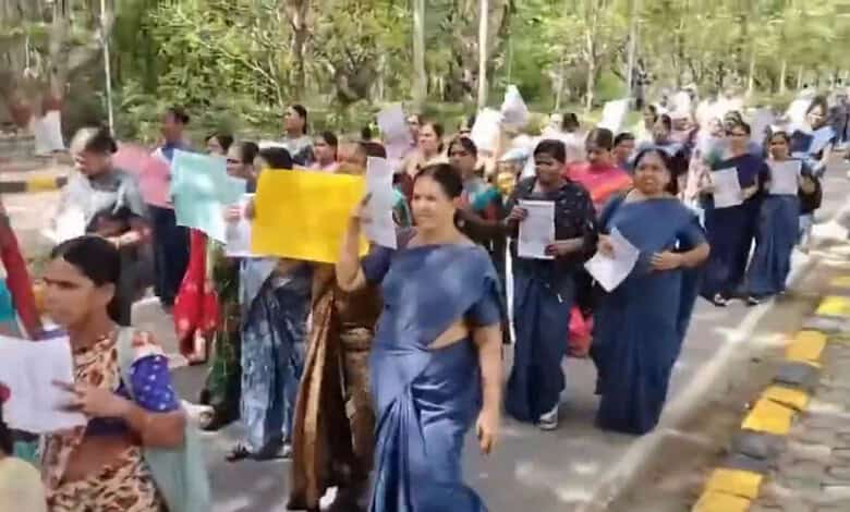 Contract workers at University of Hyderabad protest labour laws with placards and banners.