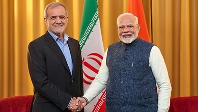 Indian Prime Minister Narendra Modi and Iran President Ebrahim Raisi shake hands at a diplomatic event.