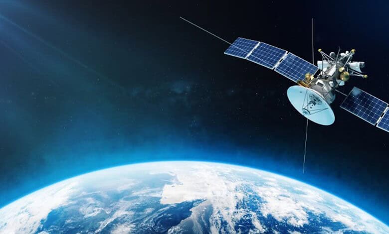 Satellite orbiting Earth with solar panels and space background.