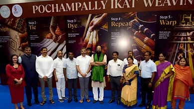 Elegant group of people at Pochampally Ikat weaving workshop, showcasing traditional textile craftsmanshi.