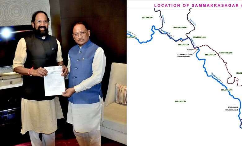 Two men exchanging documents during a formal meeting, with a map of Telangana in the background.
