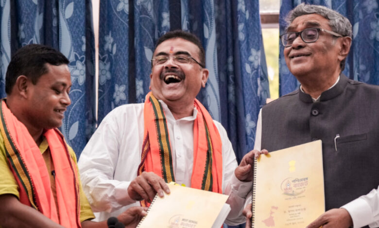 West Bengal Chief Minister Suvendu Adhikari and State Finance Minister Swapan Dasgupta display copies of the state Budget after its presentation in the West Bengal Legislative Assembly, in Kolkata