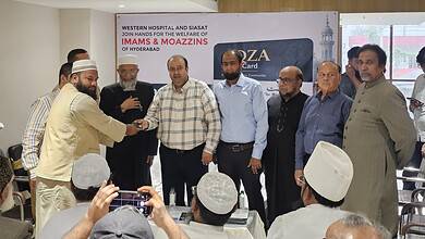 Group of Imams and officials at Western Hospital receiving healthcare cards in Hyderabad.