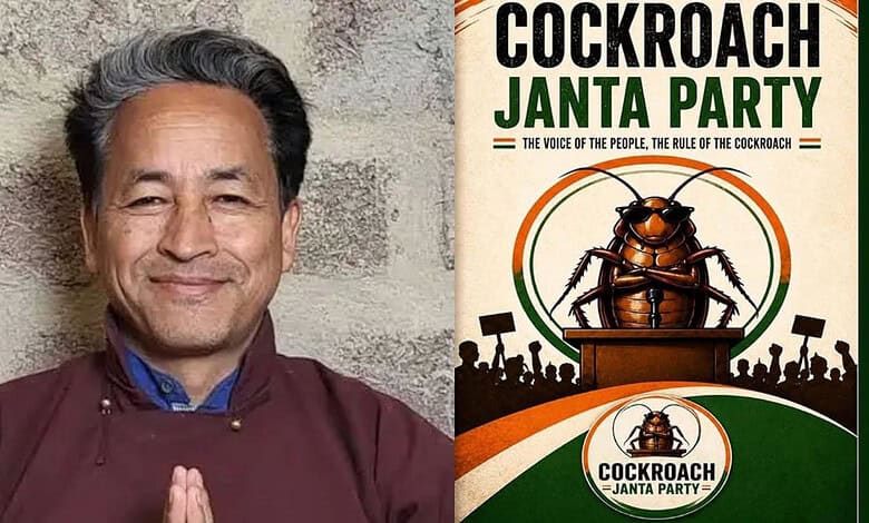 Man smiling with hands in prayer pose next to Cockroach Janta Party poster.
