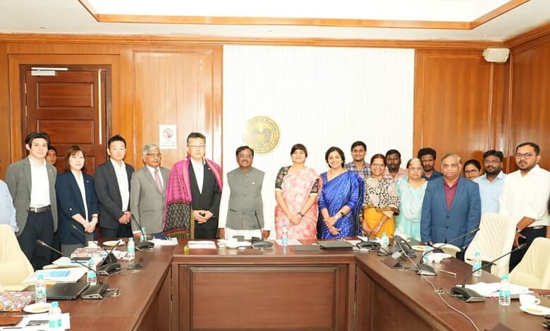 A diverse group of professionals gathered in a conference room for a formal meeting at The Siasat Daily.