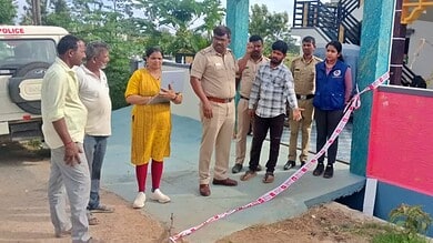Group of people, including police officers, gathered at a crime scene in Chikkamagaluru.