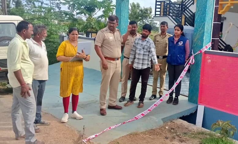Group of people, including police officers, gathered at a crime scene in Chikkamagaluru.