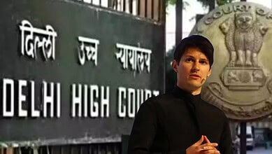 Young man standing outside Delhi High Court with sign in Hindi and English.