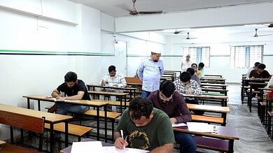 Students taking the MS IAS Academy entrance exam in a well-lit classroom.