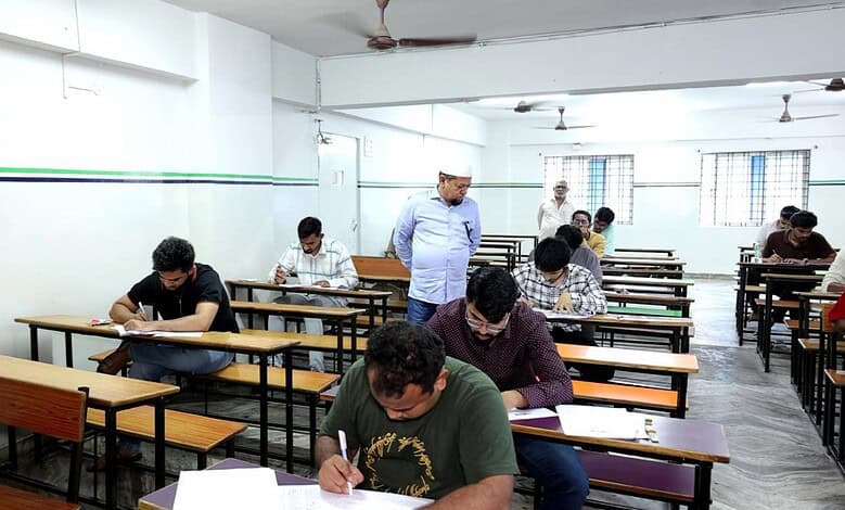Students taking the MS IAS Academy entrance exam in a well-lit classroom.