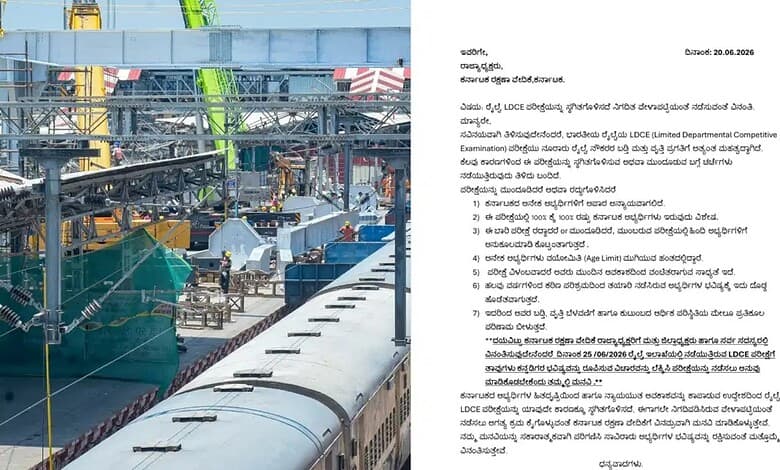 Construction site with cranes and railway tracks, no people visible, during daytime.