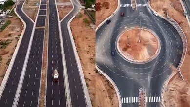 Newly constructed Bengaluru road with a roundabout and multiple lanes for smooth traffic flow.
