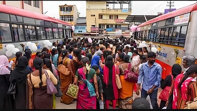 Crowd of women and men at Tirupati bus station, some holding balloons, in Telangana.