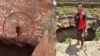 Young man exploring ancient rock carvings and archaeological site outdoors.