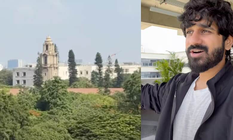 Lush greenery and historic buildings at IISc Bengaluru with a man enjoying the view.