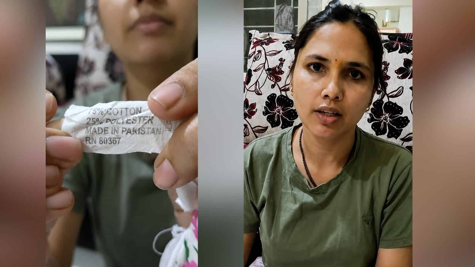 Woman holding a torn medical mask, explaining health concerns in an interview setting.