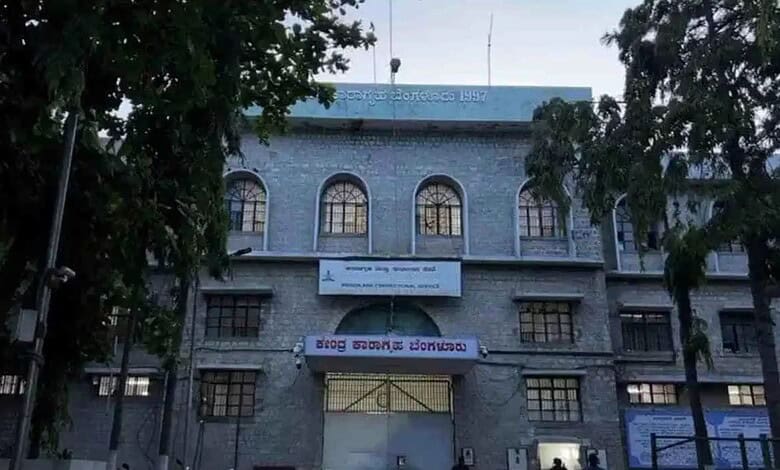 A woman walking past the historic Siasat Daily building in Hyderabad, showcasing its traditional architec.