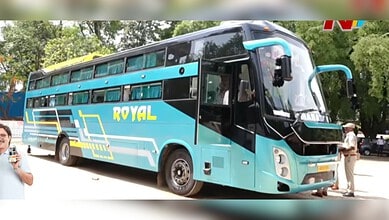 Blue and black double-decker bus with 'Royal' branding parked outdoors.