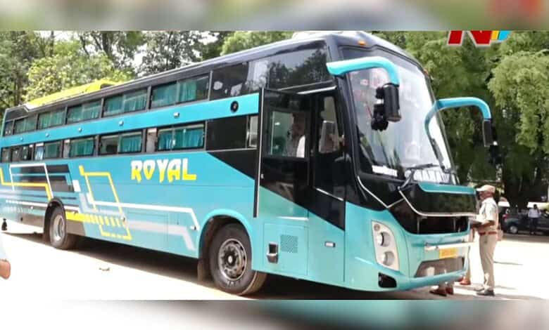 Blue and black double-decker bus with 'Royal' branding parked outdoors.