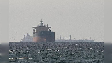 Oil tanker navigating the ocean with a clear sky, showcasing maritime industry and shipping logistics.