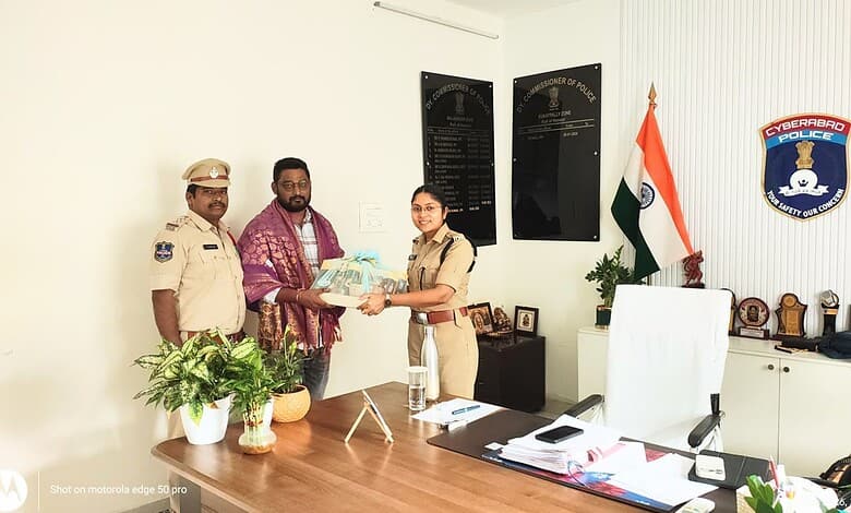Police officer handing over documents to citizen in office, Siasat Daily news coverage.