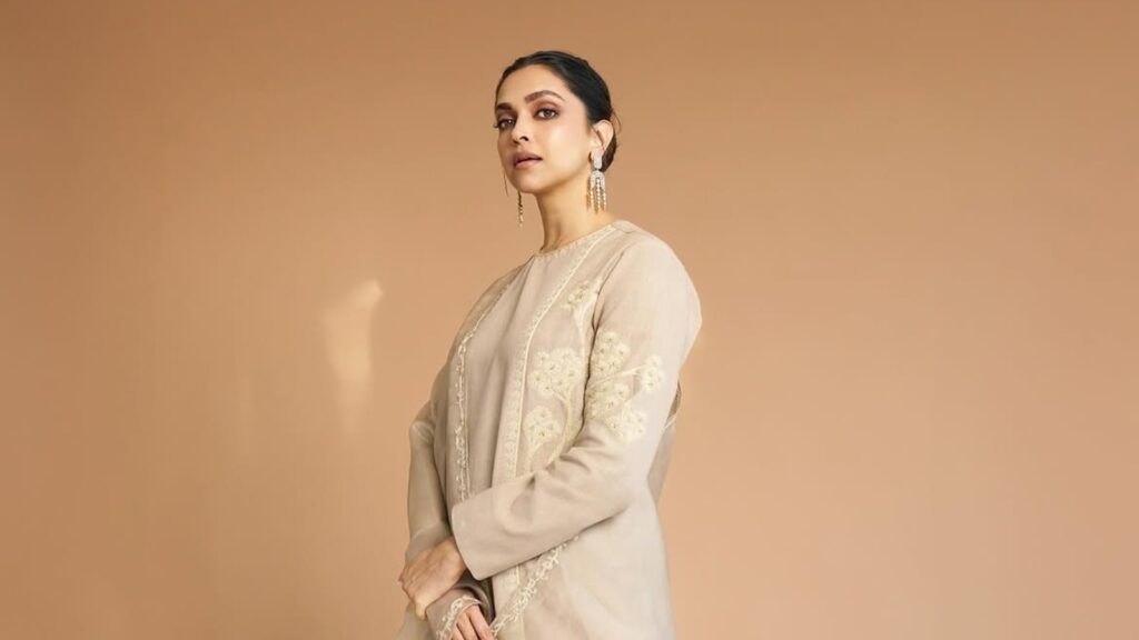 Deepika Padukone in traditional attire with elegant earrings, posing gracefully.