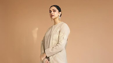 Deepika Padukone in traditional attire with elegant earrings, posing gracefully.