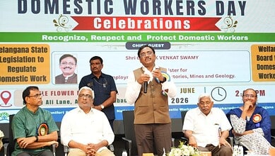 Telangana government hosts Domestic Workers Day celebration with speakers and attendees.