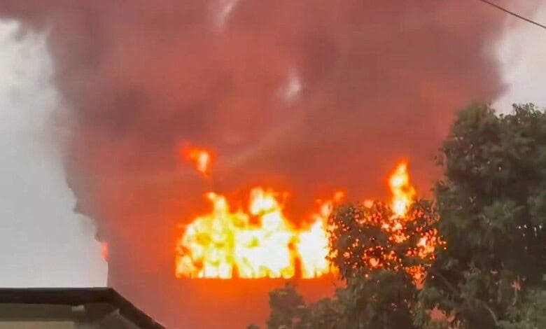 Fire outbreak in a forest with large flames and dense smoke, highlighting environmental hazards.