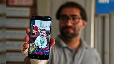 Child taking a selfie with a smartphone in a library setting.