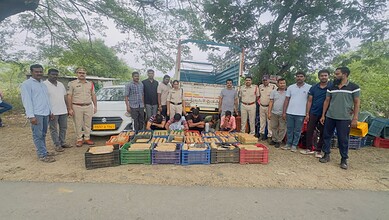 Community members with seized goods and police officers at a roadside location.
