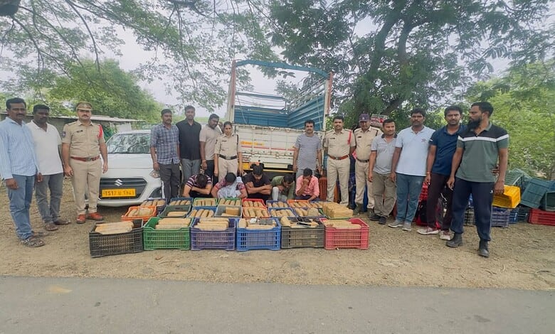 Community members with seized goods and police officers at a roadside location.