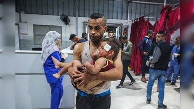A man with injuries being assisted in a medical facility in Gaza, amid ongoing conflict.
