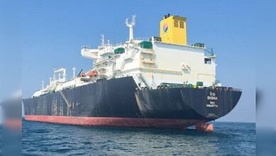 Oil tanker ship sailing on the ocean under a clear blue sky, showcasing maritime transportation and shipp.