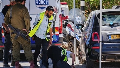 Israeli security forces and ZAKA rescue service volunteers respond at the scene of a shooting attack carried out by a Palestinian citizen of Israel near Tzur Yitzhak in central Israel, Sunday, June 7, 2026. (AP Photo/Ariel Schalit)