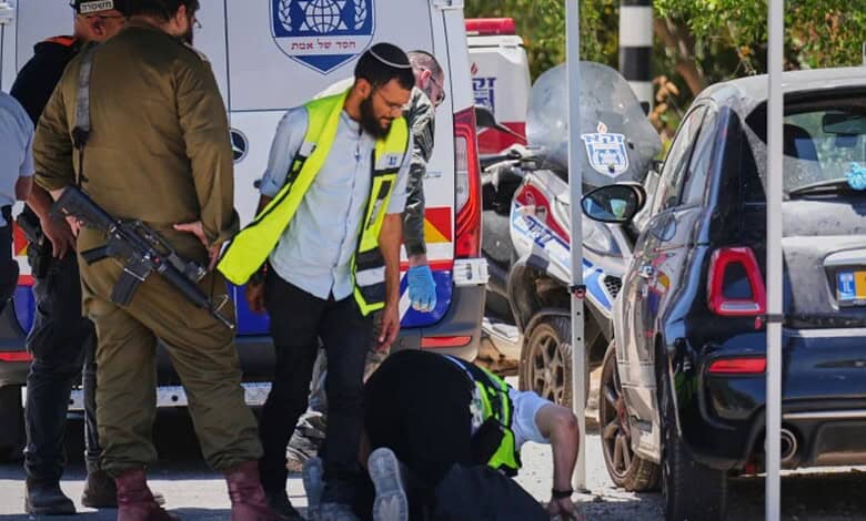 Israeli security forces and ZAKA rescue service volunteers respond at the scene of a shooting attack carried out by a Palestinian citizen of Israel near Tzur Yitzhak in central Israel, Sunday, June 7, 2026. (AP Photo/Ariel Schalit)