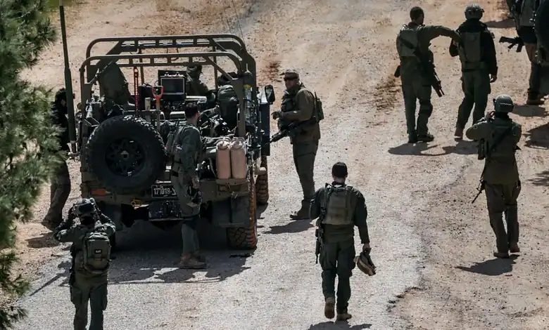 Israeli soldiers stand beside a military vehicle in southern Lebanon during a security operation.