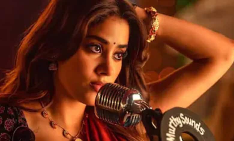 A woman speaking into a vintage microphone during a performance or event, wearing traditional attire and.