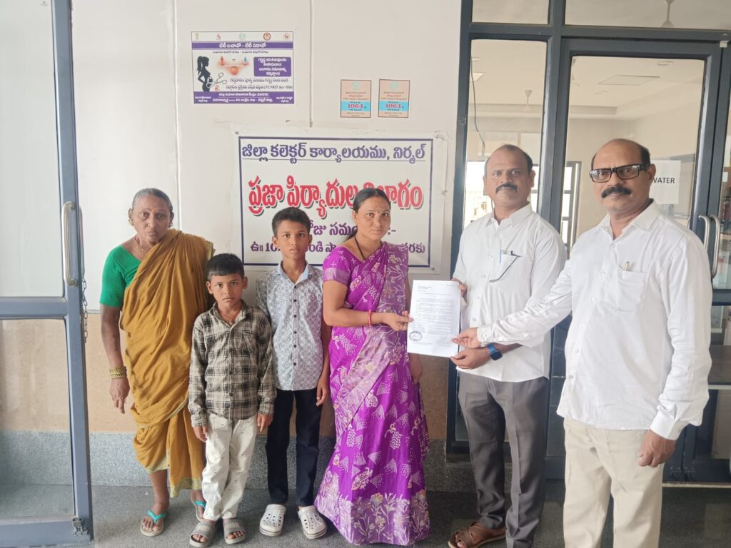 Kasthuri Swapna, wife of stranded Oman worker Muthyam Kasthuri, submits a petition to Telangana State NRI Advisory Committee member Swadesh Parikipandla in Nirmal district.