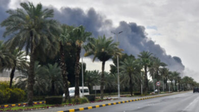Black smoke billows into the sky near Kuwait International Airport following a reported drone strike in Kuwait City.