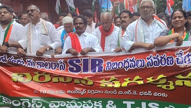 Group of protesters holding a banner during a rally for farmers' rights in India.