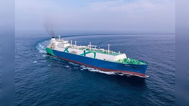 Oil tanker ship navigating through open waters with a clear sky and calm sea.