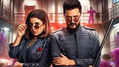 A woman and man dressed in stylish, dark clothing with sunglasses, standing confidently in an elegant, vi.