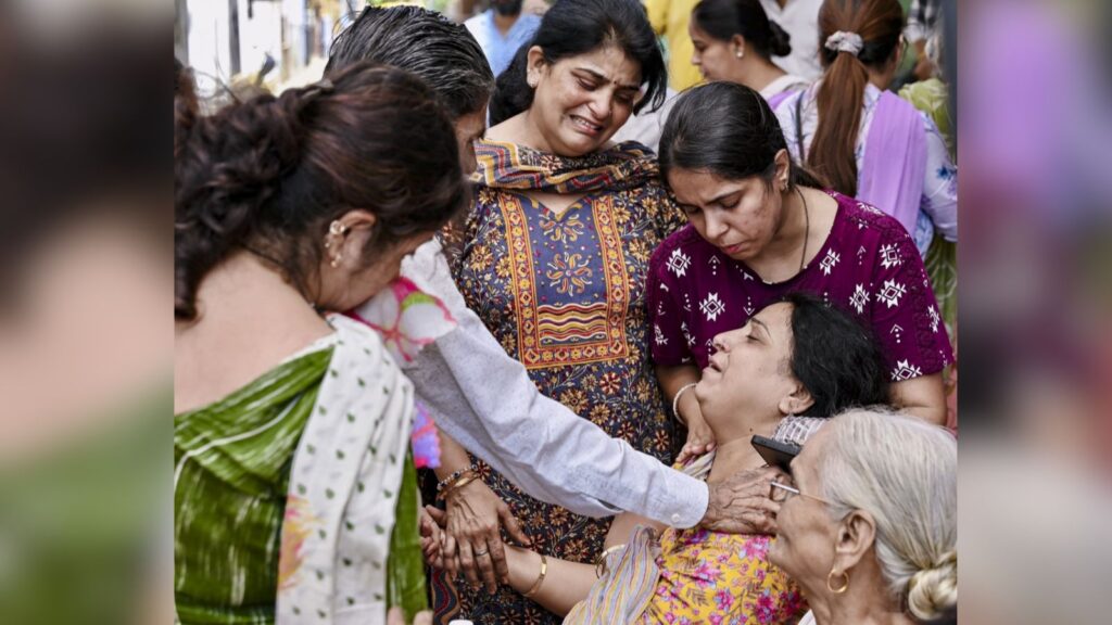 Women comforting a woman in distress at a social gathering in India.