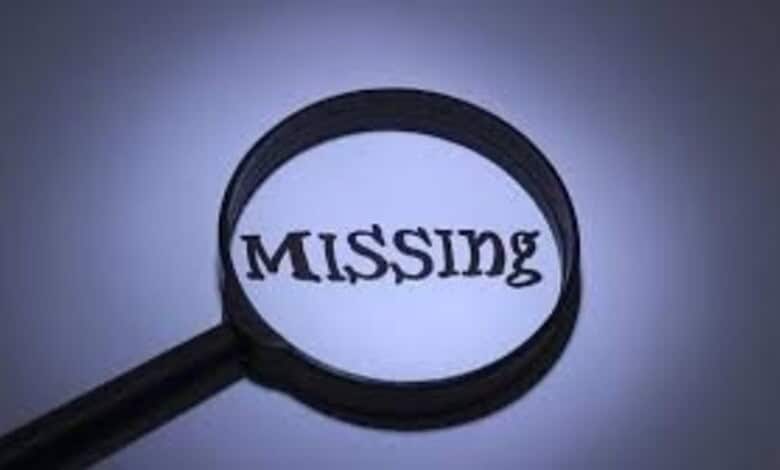 Magnifying glass highlighting the word 'MISSING' on a dark background.