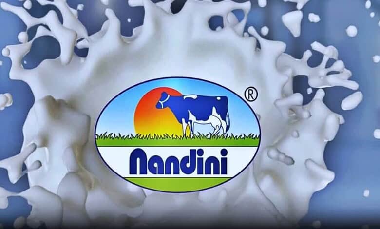Nandini Dairy Milk logo splashing into milk, symbolising freshness and quality.