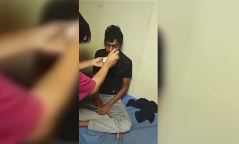 Young woman undergoing a nasal swab test for COVID-19 by a healthcare worker.