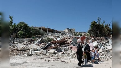 Earthquake destruction scene showing family walking through rubble and debris in an urban setting.