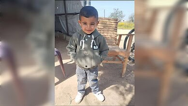 Young boy smiling outdoors in casual clothing at The Siasat Daily.