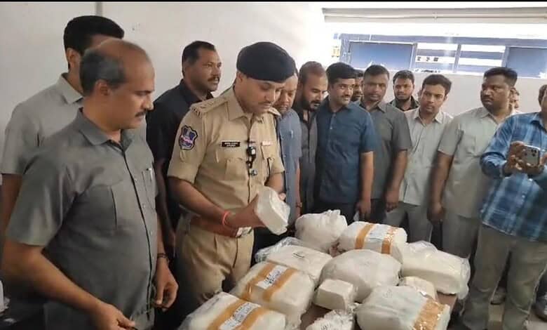 Police officer inspecting seized adulterated paneer with group of men in background.